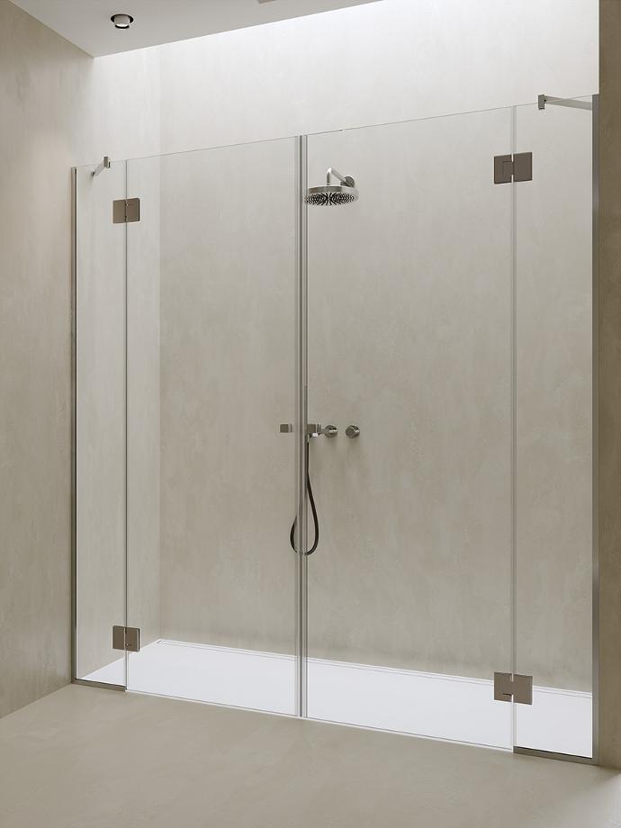 Shower cabin in a niche with double central pivot doors and two fixed glass panels.