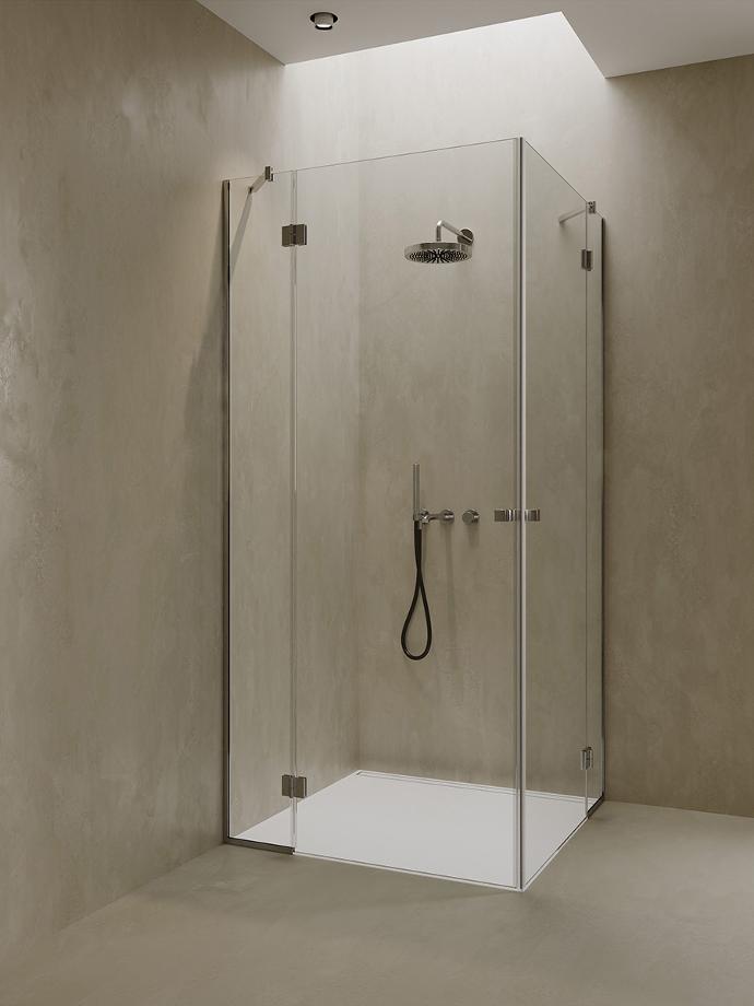 Corner shower cabin with double glass doors and fixed glasses.