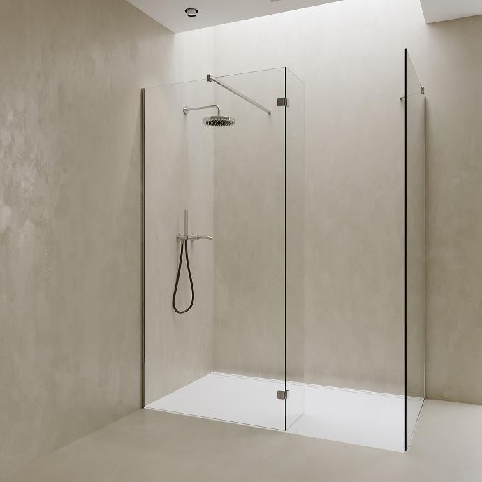 Corner walk-in shower with two fixed glass panels and splash protection.