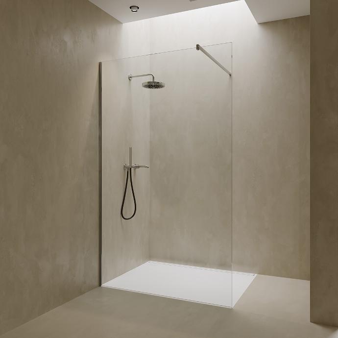 Walk-in shower in a niche with one fixed glass panel.