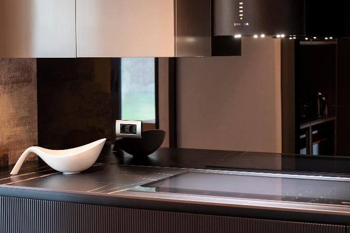 Kitchen elements and glass backsplash, mirror.