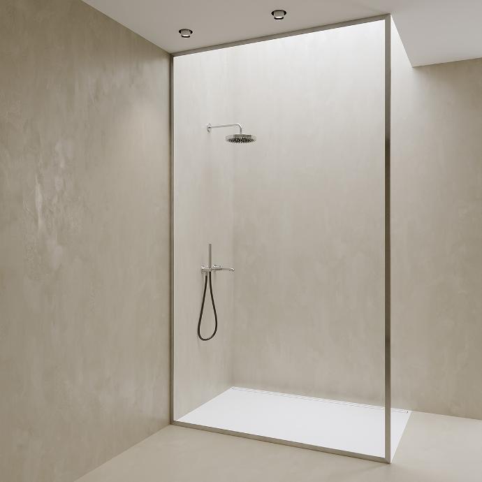 Walk-in shower in a niche with one full-height fixed glass panel.