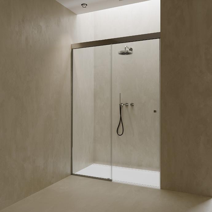 Shower cabin with sliding glass doors in a niche.