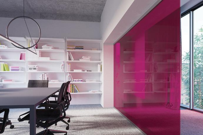 A modern office with a red transparent glass partition, office chairs, a table and shelves.